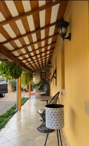 a patio with chairs under awning and a table at Curlt stays in Kampala