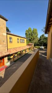 a view from a balcony of a yellow building at Curlt stays in Kampala +20 photos