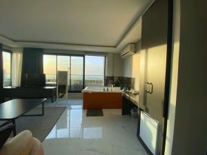 a large bathroom with a tub and a table at Elite Marmara Bosphorus Çamlıca in Istanbul