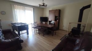 a living room with a table and a dining room at Vikos-Spa in Rzeczyca