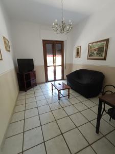 a living room with a couch and a table at Maurin in Carrara