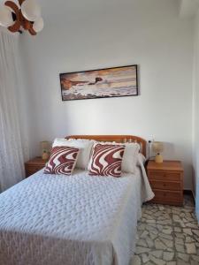 a bedroom with a bed with two pillows on it at O Curro de Arou in Arou