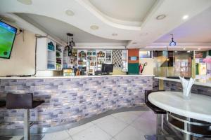 a bar in a restaurant with a table and chairs at Capital comfort Hotel Ambala Rd in Nairobi +10 photos