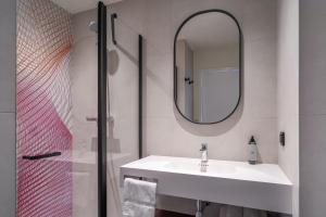 a bathroom with a sink and a mirror at Prize by Radisson, Gdansk in Gdańsk
