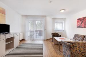 a living room with a couch and a table at Parkblick Doppelzimmer 26, 29 in Bad Dürrheim