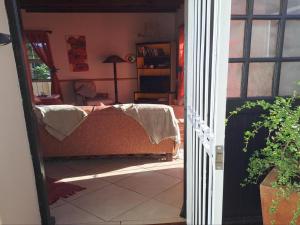 an open door to a living room with a table at A1Bay View Guest House Cottage & Apartment SEA FACING in Jeffreys Bay