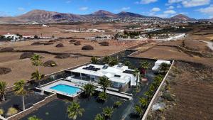 an aerial view of a house with a swimming pool at Villa Las Palmitas - Sea Views - Private Pool - Hot Tub - Table Tennis in Puerto Calero