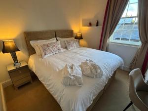 a bedroom with a bed with towels on it at Apartment No.1 in Lincoln