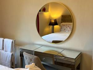 a mirror in a bedroom with a bed and a desk at Apartment No.1 in Lincoln +9 photos