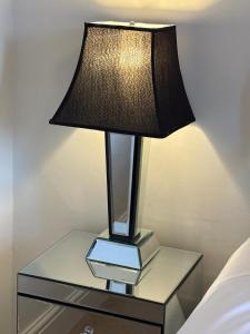 a table with a lamp on top of a bed at Apartment No.1 in Lincoln