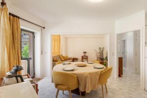 a living room with a table and a couch at On the Beach at Amorosa in Viana do Castelo