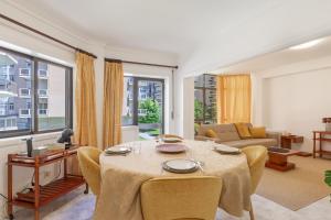 a living room with a table and a couch at On the Beach at Amorosa in Viana do Castelo +21 photos
