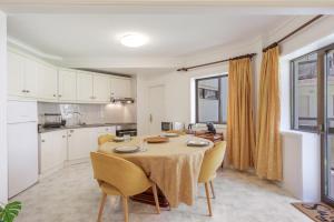 a kitchen and dining room with a table and chairs at On the Beach at Amorosa in Viana do Castelo