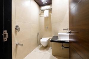 a bathroom with a toilet and a sink at Hotel BKC Suite in Mumbai