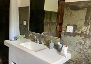 a bathroom with a sink and a mirror at Villa Rita in Gede +40 photos
