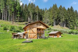 a cabin in the middle of a grass field at Bnb Erba Maga in Rabbi