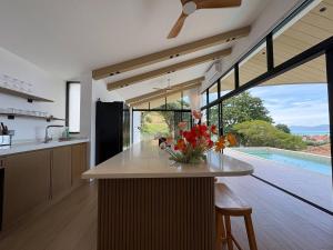 a kitchen with a counter with a vase of flowers on it at Villa 7 Ocean View Pool Villa in Bophut