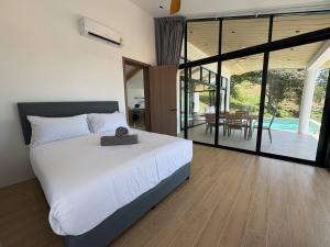 a bedroom with a large white bed and a dining room at Villa 7 Ocean View Pool Villa in Bophut +35 photos