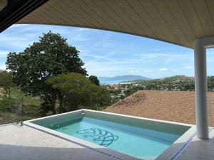 a swimming pool on the roof of a house at Villa 7 Ocean View Pool Villa in Bophut