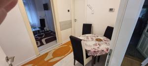 a table and chairs in a room with a dining room at AMY APARTMAN in Tuzla +2 photos