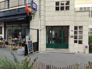 a store front with a green door on a street at Votre expérience insolite - Clair de lune in Caen