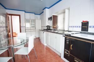 a kitchen with a glass table and white cabinets at Aberasturi in Gautegiz Arteaga