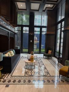 a living room with a couch and a table at Modern Condo-Pool&Gym-ROW in Ban Rangeng