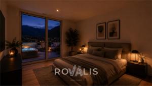 a bedroom with a large bed and a large window at Brig Panorama Spa in Brig