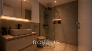 a bathroom with a sink and a glass shower at Brig Panorama Spa in Brig