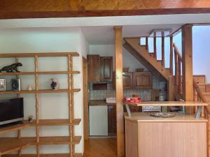 a living room with wooden shelves and a staircase at Una Serenity Villa in Bare +28 photos