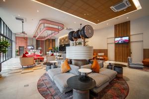 a living room with a couch and a table at Grand Mercure Krabi Ao Nang in Ao Nang Beach