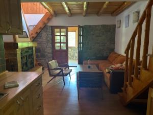 a living room with a couch and a fireplace at Una Serenity Villa in Bare