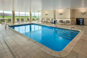 a large pool with blue water in a hotel room at SpringHill Suites by Marriott Buffalo Airport in Williamsville
