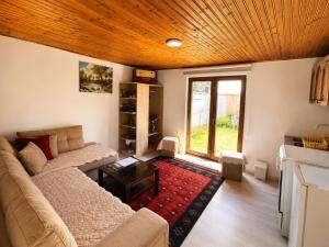 a living room with a couch and a table at Garden Guesthouse in Gjakove