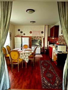 a kitchen with a table and chairs in a room at Komani Hideout in Podgorica