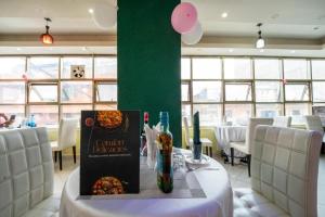 a restaurant with a table with a book on it at Capital comfort Hotel Ambala Rd in Nairobi