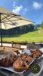 a bunch of pastries on plates on a table at Chalet Monte Coston in Lastebasse