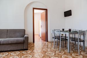a living room with a table and chairs and a couch at Villa Lucia in Caorle