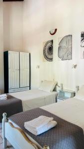 a room with two beds and two pictures on the wall at Villa Amy in Achladies