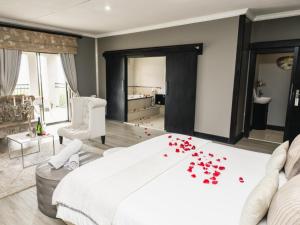 a bedroom with a bed with red hearts on the floor at Altissimo Guesthouse in Bloemfontein +50 photos
