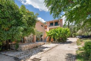 an image of a house with a driveway at Odysseia Beachside Apartments in Nikiana