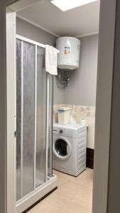 a laundry room with a washing machine and a washer at La camera a Lido Burrone in Favignana +10 photos