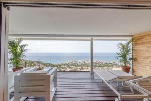 a balcony with a view of the ocean at Sitges Suites - Premium in Sitges