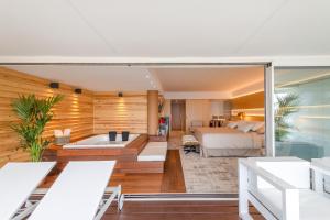 a living room with a bedroom and a bed at Sitges Suites - Premium in Sitges