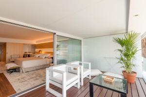 a bedroom with a bed and a living room at Sitges Suites - Premium in Sitges