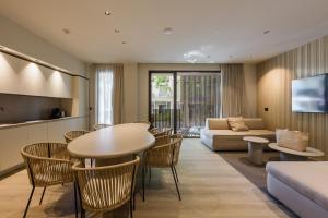 a living room with a table and chairs and a couch at Evangelisti Palace in Bellaria-Igea Marina