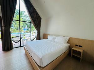 a bedroom with a bed and a large window at Khaosok Sunset Resort in Khao Sok National Park +65 photos
