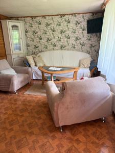 a living room with couches and a table at UKRYTY SKARB in Głobikówka