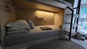 a bedroom with a bunk bed with a book at silom lestay纯女民宿 in Yan Nawa