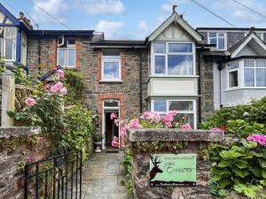 a house with flowers in front of it at Pips Corner Lynton in Lynton